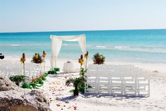 an outdoor wedding setup on the beach