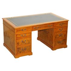 an old wooden desk with glass top and drawers on the bottom drawer is shown against a white background