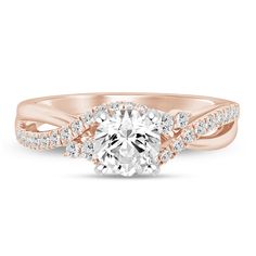 a rose gold engagement ring with an oval center stone and two rows of diamonds on the band