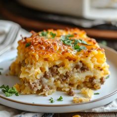 a close up of a plate of food with meat and cheese casserole on it