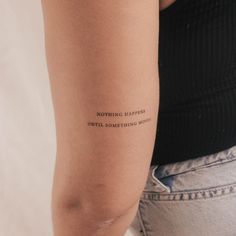 a woman's arm with a tattoo saying nothing happens until something moves on it