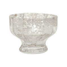 a glass bowl sitting on top of a white table