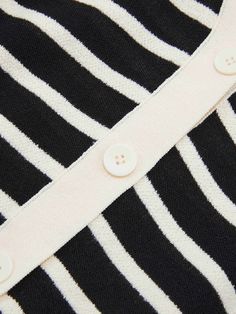 MO&Co. Women's Short Sleeve Contrast Cardigan This classic black and white striped cardigan features a stylish v-neck and puff sleeves. The front is decorated with a row of beautiful buttons, making it a fashionable piece that can be styled for any occasion. Features : - Classic black and white stripes- Puff sleeve and short sleeves- V-neck with buttons along the front Code: MBC2CAR011The back length of size S is 51.5cmMATERIALS & CARE Material: 82.7% Cotton 17.3% PolyamideOur sizes might be a l Contrast Cardigan, Beige Cardigan, Striped Cardigan, Black Cardigan, Puff Sleeves, Classic Black, The Row, White Stripe, Puff Sleeve