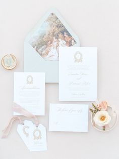 the wedding stationery is laid out on top of the table