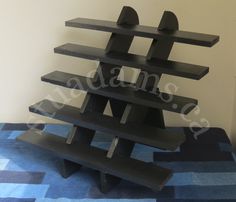 a black shelf sitting on top of a blue carpet