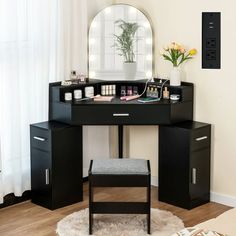 a desk with a mirror, stool and flowers on it