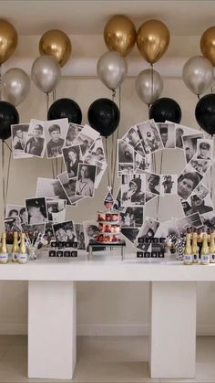 a table topped with balloons and pictures next to a cake on top of a table