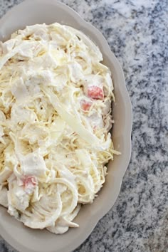 a bowl filled with coleslaw on top of a table