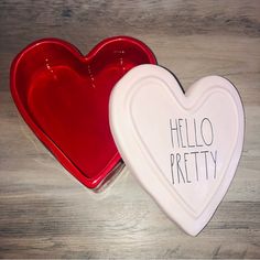 two heart shaped dishes with the words hello pretty written on them