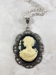 This beautiful goddess cameo necklace is the perfect way to show your love for mythology in an elegant way.This necklace features Greek goddess Persephone. Persephone is the goddess of spring and queen of the underworld. This artwork presents her in her spring maiden aspect.Available in a variety of lengths. Secured with a lobster clasp that can fit in any of the links on the chain, making it easily adjustable.All materials are lead and nickel free. Frame and chain are made out of zinc alloy. Ca Gothic Cameo Necklace As Gift, Gothic Cameo Necklace For Gift, Gothic Cameo Necklaces As Gift, Gothic Cameo Necklaces For Gifts, Victorian Necklace For Gift, Antique Silver Victorian Necklace, Greek Goddess Persephone, The Goddess Of Spring, Goddess Persephone