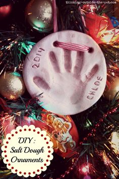 a handprint ornament on a christmas tree with ornaments around it and the words diy salt dough ornaments