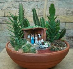 a potted planter filled with succulents and small figurines