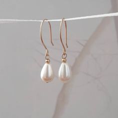 "Teardrop Pearl Earrings These bridal earring are definitely  my favorite pair thanks to their simplicity and for  how well it goes with every bridal gown style. Adds a classic bridal look, you will wear them long after your wedding. The earrings are made of gold filled and pearl. Dimensions-  Length - 1.2\" Pearl - 0.55\" *0.25\"  ❤ Thank you for stopping by ❤                                                      Want to see more ? Teardrop Earrings Wedding, Bridal Earrings Gold, Bridal Pearl Earrings, Matte Gold Earrings, Pearl Teardrop Earrings, Teardrop Pearl Earrings, Teardrop Bridal Earrings, Bridal Earring, Pearls Earrings