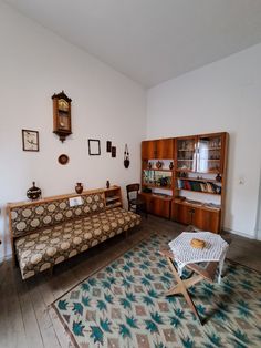 a living room with a couch, coffee table and other items on the floor in it