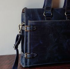 Elevate your style and protect your essentials with our Vintage Two-Tone Blue Handmade Leather Laptop Bag for Men. Crafted with precision and attention to detail, this bag is not just a practical accessory; it's a statement of sophistication. Made from genuine leather, this laptop bag features a unique two-tone blue design that adds a touch of vintage charm. The handcrafted construction ensures that it's not only stylish but also built to last. With ample space for your laptop, documents, and personal items, this bag is the perfect companion for your workday, business meetings, or casual outings. The adjustable shoulder strap provides comfort and convenience, making it a versatile addition to your wardrobe. Embrace the blend of classic and contemporary design, and make a lasting impression Blue Briefcase For Everyday Use, Blue Leather Travel Briefcase, Blue Leather Briefcase For Travel, Blue Leather Briefcase For Business, Classic Blue Briefcase For Daily Use, Blue Briefcase For Daily Use, Blue Everyday Satchel Briefcase, Classic Blue Leather Briefcase, Blue Rectangular Satchel With Leather Lining