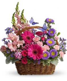 a basket filled with lots of colorful flowers