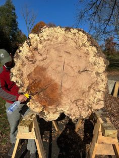 a man is working on a large piece of wood