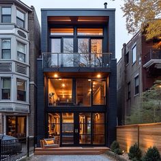 an apartment building with lots of windows and lights on the side of it's sides