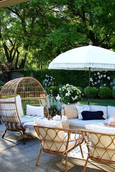 a patio with wicker furniture and an umbrella