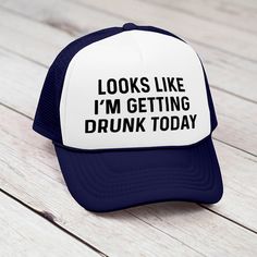 a white and blue trucker hat that says looks like i'm getting drunk today