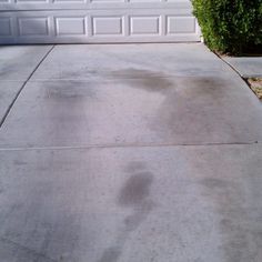 a red fire hydrant sitting in front of a white garage door