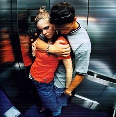 two people hugging each other in an elevator