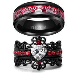 two wedding rings with red and black diamonds on each side, one has a heart shaped diamond