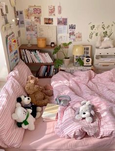 there are stuffed animals on the bed in this small room with pink sheets and pillows