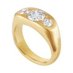 a gold ring with three diamonds on it