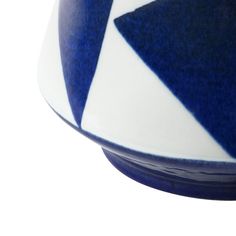 a blue and white bowl sitting on top of a table