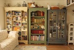 a living room filled with lots of furniture and bookshelves next to each other