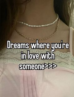 a girl with long hair wearing a pink shirt and necklace that says, dreams where you're in love with someone > >