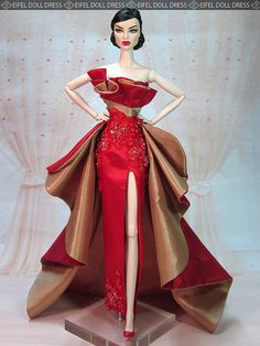 a barbie doll wearing a red and gold gown with high slits on the skirt