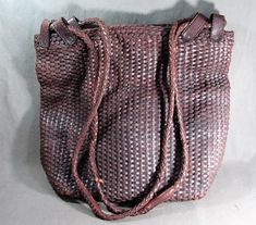 "Very large tote bag by J. Peterman, woven leather in chocolate brown, with black fabric interior, long woven leather handles, ca 1995. Measures 16 1/2\" x 14 1/2\" x 5 1/4\", with double handles that are each 41\" long from loops on bag. Bag is lined with heavy black cotton, and has a zippered pocket. The handles are one continuous section, and are attached with four wide leather loops on each side. Loops are held with metal rivets. The bag is very durable, holds a lot, and is great looking. Ta Woven Leather Tote, J Peterman, Leather Bucket Bag, Deep Brown, Woven Bag, Large Tote Bag, Leather Handles, Bag Bag, Leather Wraps