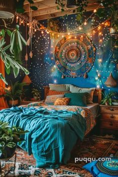 a bedroom decorated in blue and green with lights hanging from the ceiling, plants on the bed