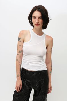 Crafted from an open gauge, semi-sheer rib fabric, this high-neck tank features a unique bias cut designed to twist when worn. Showcasing an asymmetrical hem and is finished with a red-stitched EL logo on the lower left front. Modern Fitted White Tank Top, Asymmetrical Fitted Tank Top For Layering, Fitted Asymmetrical Tank Top For Layering, Casual White Asymmetrical Tank Top, Fitted Casual Tank Top With Asymmetrical Hem, Casual White Tank Top With Asymmetrical Hem, Black Asics, Eckhaus Latta, Rib Fabric