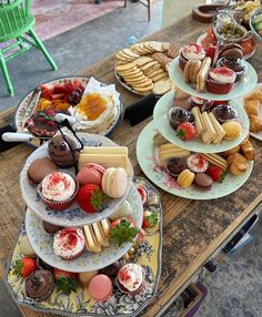 a table topped with lots of different types of cakes and pastries next to each other