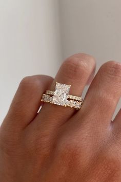 a woman's hand with a diamond ring on it