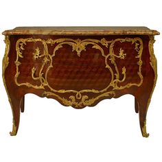 an ornately decorated wooden chest with gold accents