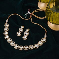 Step-in to the aura of timeless elegance with this must-have piece adding a touch of class to any ensemble! Embellish your look with subtle sophistication and enhance your style with this exquisite set crafted with luxurious and dazzling polki jadau kundan stones. The set includes a necklace and a pair of push-back earrings. Approximate earrings length is 1.5". Gold-plated on high-quality brass as base metal. In-stock & ready-to-ship. *Please Note: We use faux stones and beads in all of our jewe Festive Round Kundan Necklace Gold Plated, Festive Round Gold-plated Kundan Necklace, Bollywood Style Gold Plated Kundan Necklace, Gold Plated Round Kundan Necklace Bollywood Style, Elegant Kundan Sets With Meenakari Detailing, Festive Gold-plated Hand Set Kundan Necklace, Gold Kundan Sets For Reception, Kundan Necklace With Gota Work, Kundan Jewelry Sets With Cutdana For Celebration