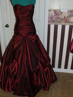 This is a custom made taffeta gown.  It is made to the specifications of each customer as ordered.   It is made of  taffeta, but can be created in another fabric of your choosing..  The bodice is boned for added support and the gown is fully lined.  The back is a corset style and the skirt has pick-ups for fullness. If made in silk taffeta, there will be an additional cost of $350.00. This gown is made of 13 yards of the taffeta and habotai lining. Gown show with very full crinoline.  Crinoline is not included, but  can be added for a price of $85.00. Please allow 6-8 weeks for completion of the gown. If you are interested in a custom made gown in any style, please contact me and send a picture of what you are wanting and I will send you a quote for creating it.    VAT Fees or Any other fe Taffeta Wedding Dress With Sweep Train, Wedding Dress With Sweep Train In Taffeta, Red Fitted Satin Ball Gown, Fitted Taffeta Gown For Wedding, Satin Finish Ball Gown With Fitted Bodice, Fitted Taffeta Dress For Wedding, Fitted Taffeta Wedding Dress, Floor-length Taffeta Wedding Dress, Fitted Ball Gown With Pleated Bodice For Evening