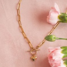 This heart necklace is secured with a toggle clasp, adding a touch of elegance to its chunky design. This statement piece can elevate any outfit, offering a mix of edgy and romantic vibes. …………………………………. Details: Pendant is Thick Gold Plated and measures 9mm x 9mm Chain is Stainless Steel Paperclip Average necklace length is 18" About Your Jewelry If you are not wearing your jewelry it is best to store it in a cool, dry place such as your gift box that is included in your order. Metal Necklaces With Heart Pendant And Toggle Clasp, Chic Metal Necklace For Valentine's Day, Elegant Heart Necklace With Chunky Chain For Gift, Chic Everyday Necklaces With Toggle Clasp, Chic Everyday Necklace With Toggle Clasp, Heart-shaped Metal Toggle Necklace With Adjustable Chain, Elegant Heart Pendant Toggle Necklace, Elegant Heart Toggle Necklace With Adjustable Chain, Elegant Heart Shaped Toggle Necklace With Adjustable Chain