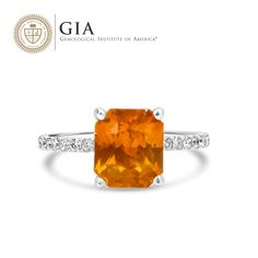 This Natural Orange Sapphire and Diamond Ring showcases a stunning 4.02 carat orange sapphire, displaying the rare and vibrant hue in a prong setting. Accentuating the center stone are natural diamonds that add sparkle and brilliance to the overall design. Make a statement with this luxurious and unique piece of jewelry. Fine Jewelry Orange Sapphire Anniversary Ring, Orange Diamond Ring As Gift, Orange Diamond Ring As A Gift, Classic Orange Topaz Ring With Prong Setting, Orange Sapphire Ring For Anniversary, Orange Topaz Ring For Anniversary, Fine Jewelry Style, Orange Diamond Gemstone Jewelry, Orange Diamond Topaz Ring With Center Stone, Orange Diamond Ring With Prong Setting