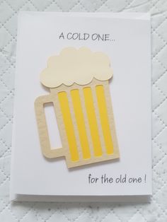 a card with a wooden cutout of a mug of beer on it that says, a cold one for the old one