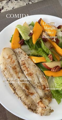 a white plate topped with meat and salad