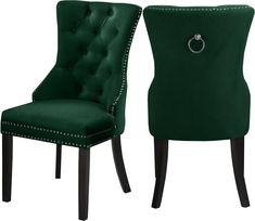 a pair of green velvet chairs with diamond buttons on the back and arms, side by side