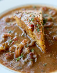 a white plate topped with soup covered in beans