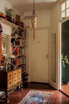 a room with bookshelves and a rug on the floor in front of it