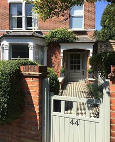 a house with a gate and brick walls