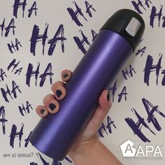 a person is holding a purple water bottle